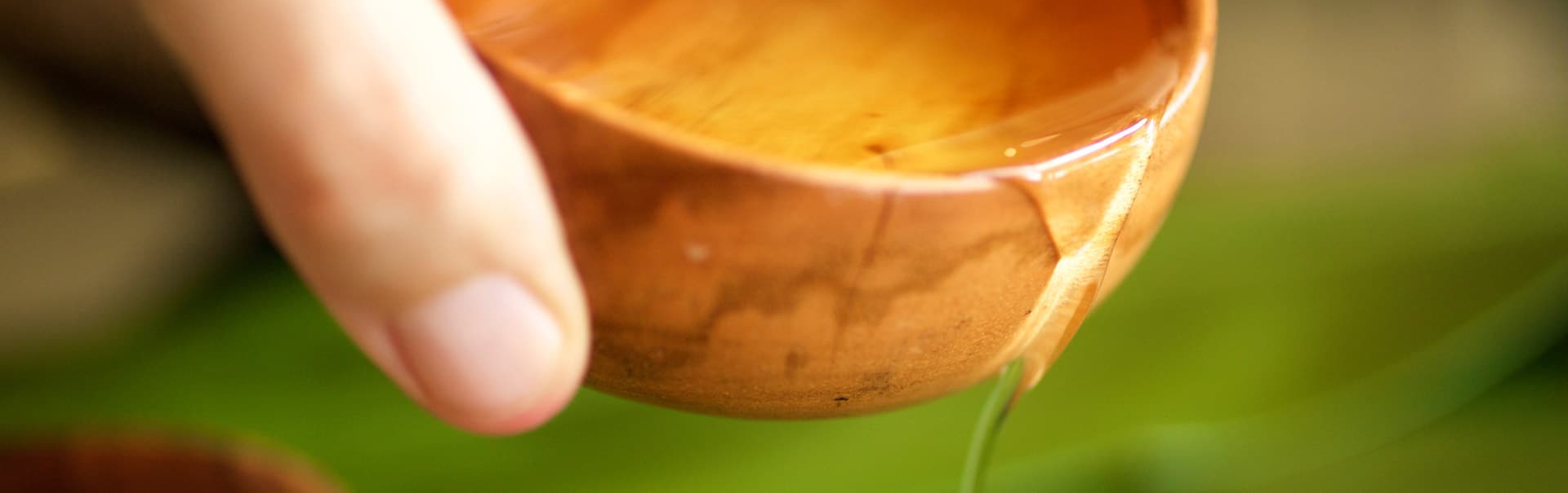 Oil pouring from a monekypod bowl